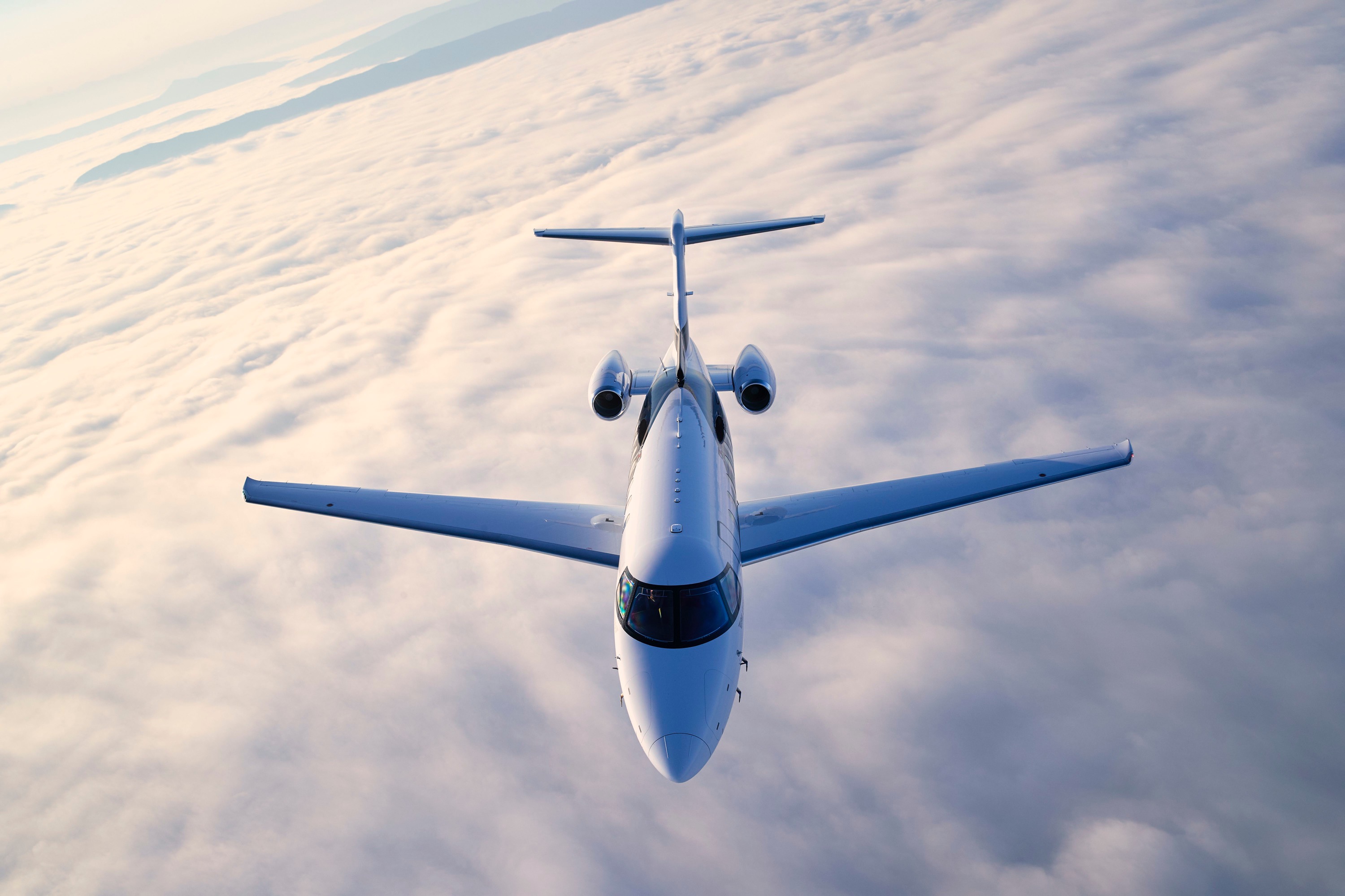 A Piedmont Jets private business jet in cruise flight high above a layer of cloud.